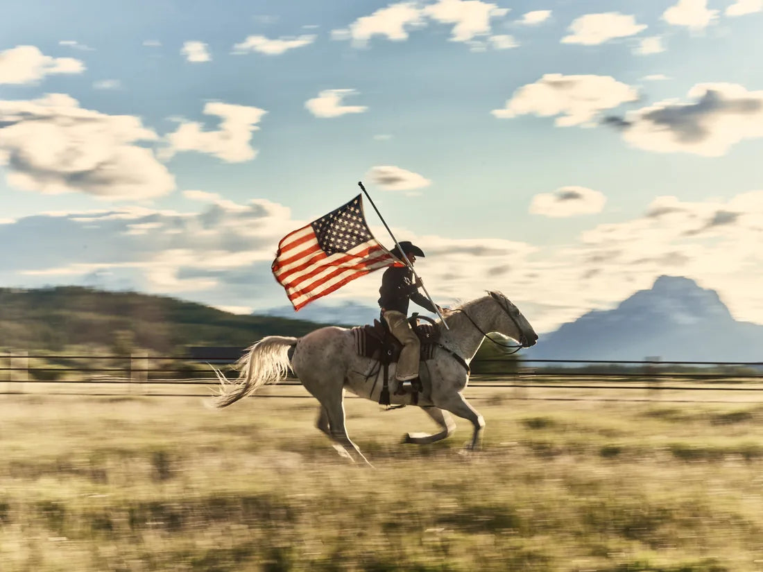 A rider carrying the American flag across the frontier